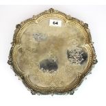 A Victorian hallmarked silver salver with engraved decoration and family crest, Dia. 28cm.