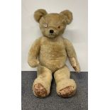 A large straw field articulated teddy bear, L. 87cm.