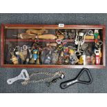 A cabinet containing an extensive collection of bottle openers, 76 x 31cm
