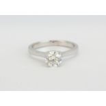 An 18ct white gold solitaire diamond ring, approx 1.08ct, ring size - O.5, with certificate (