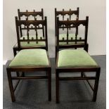 A set of four oak dining chairs.