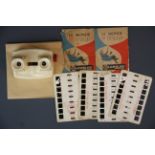 A cream bakelite Breviet colorelief stereo viewer together with a small group of slides.