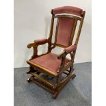 A 1920's spring controlled upholstered rocking chair.