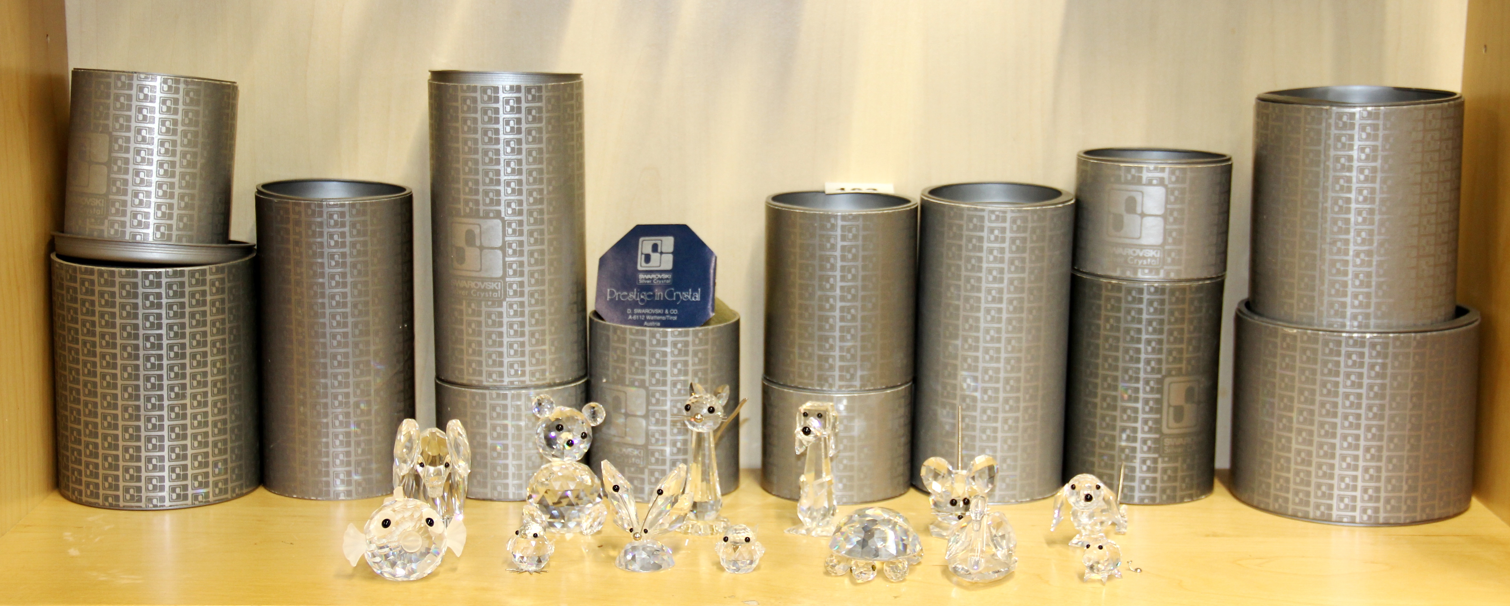 A group of 13 boxed Swarovski crystal figures.