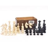 An antique turned ivory and ebony chess set, King H. 7.5cm.