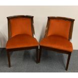 A pair of upholstered mahogany hall chairs.