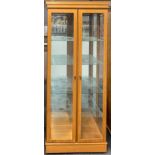 A useful glazed display cabinet, 80 x 192cm