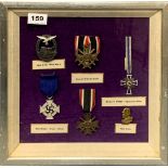 A framed group of German Nazi medals and badges (mostly original).