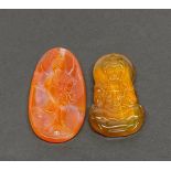 Two Chinese carved agate amulets of the goddess Guinyin, largest 6.5cm.