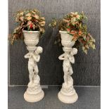 A pair of white ceramic cherub plant holders, H. 97cm.