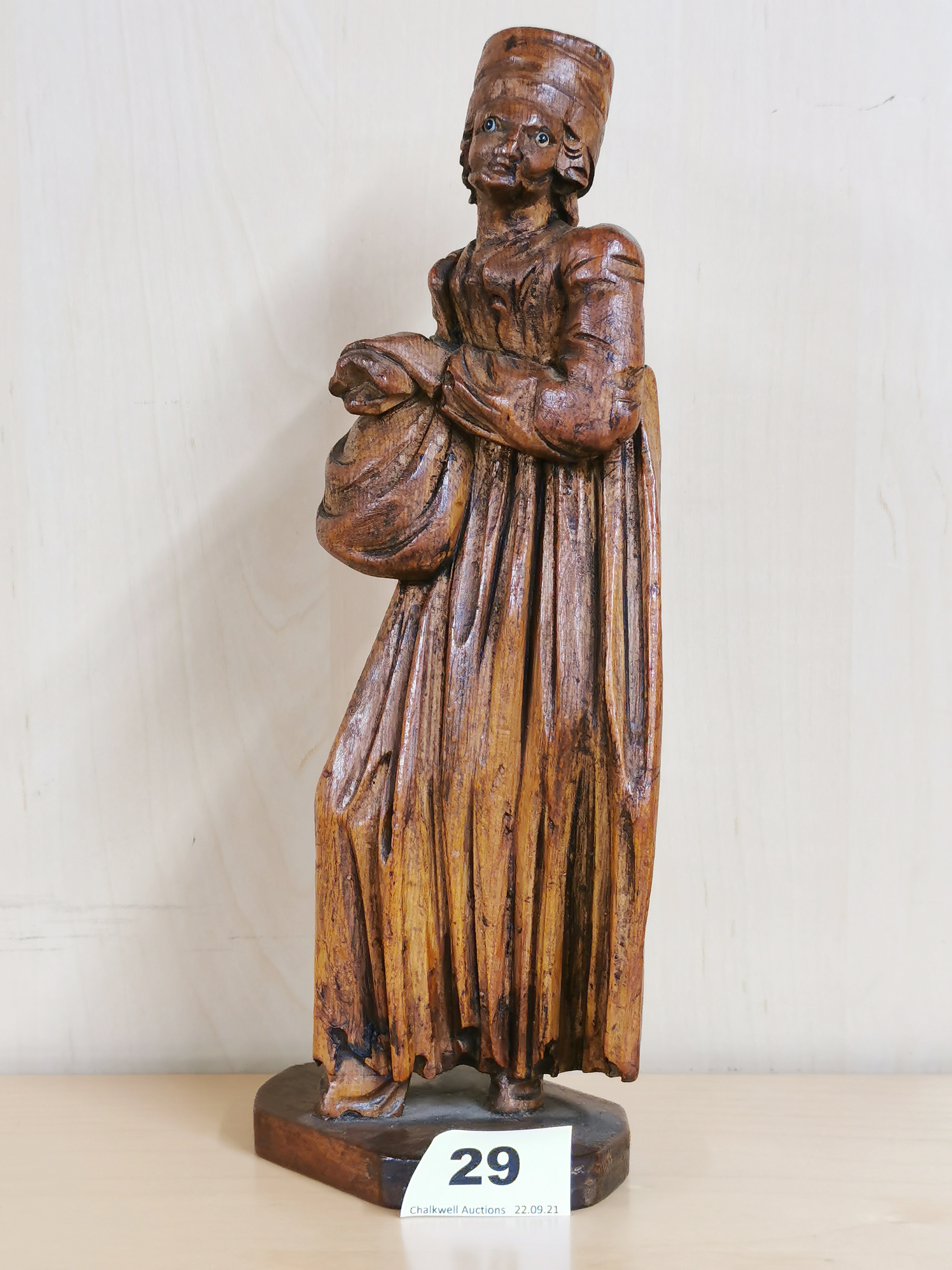 A lovely 17th C carved limewood figure of a lady with glass eyes. Notation to the base refers to