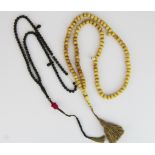 A strand of antique Tibetan yak bone prayer beads and a strand of small wooden prayer beads inset