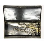 A quantity of silver plated scissors etc in a metal deep box.