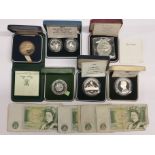 A group of mixed commemorative coins and British bank notes.