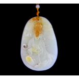 A Chinese carved white and russet jade amulet of the goddess Guanyin on a silk and white jade bead