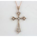 A beautiful 18ct rose and white gold diamond set cross with an 18ct rose gold chain, diamond