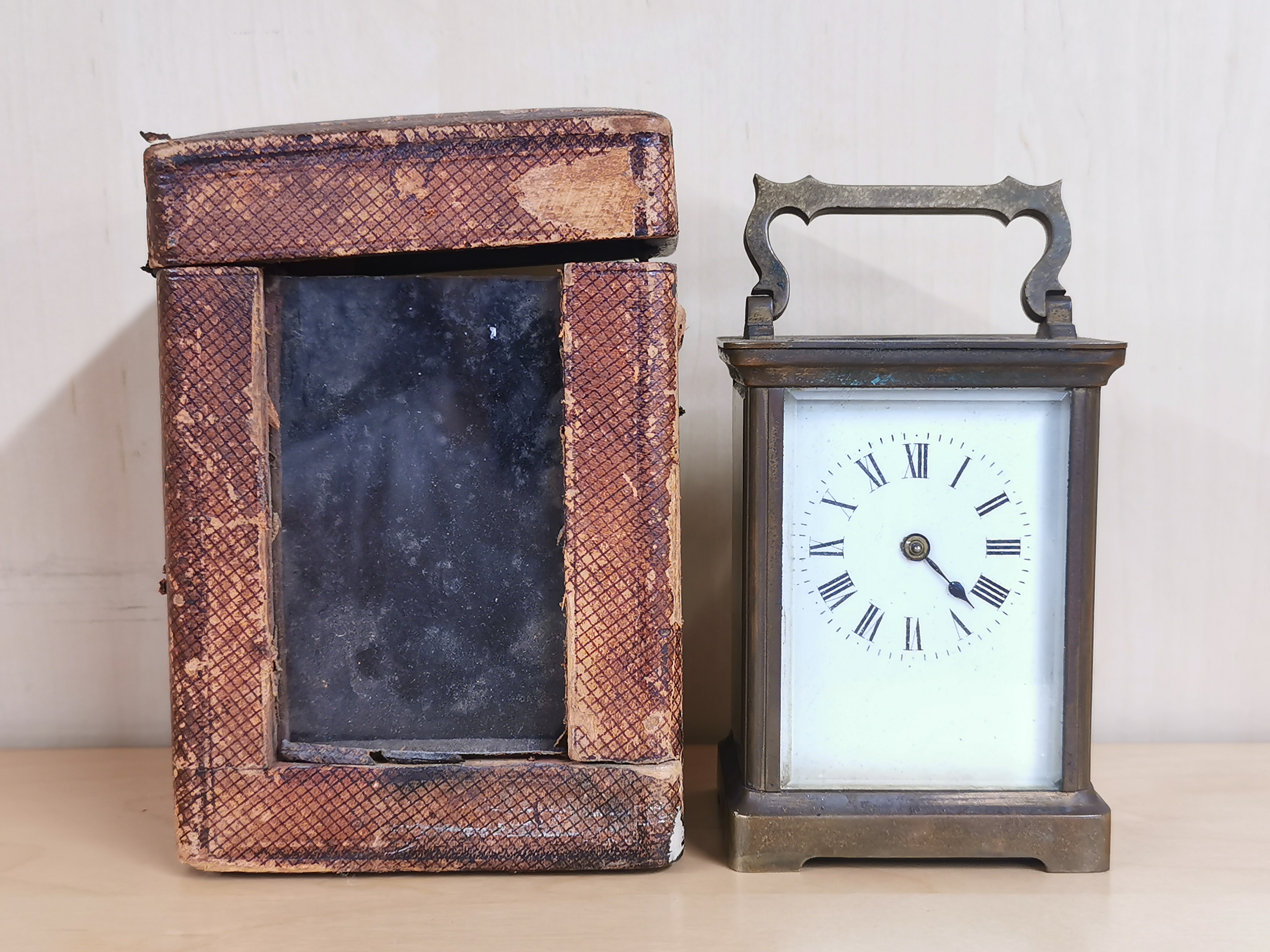 An antique brass carriage clock with carrying case, H. 14cm.