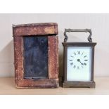 An antique brass carriage clock with carrying case, H. 14cm.