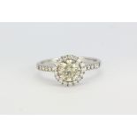 An 18ct white gold halo ring, centre stone just over 1ct, ring size - N.