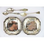 A pair of Continental silver dishes and three silver teaspoons.