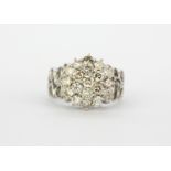 A large 18ct white gold cluster ring set with brilliant cut diamonds, approx. 1.26ct overall, (O).