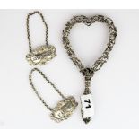 A pair of hallmarked silver port and sherry decanter labels and a heart shaped hand mirror frame,