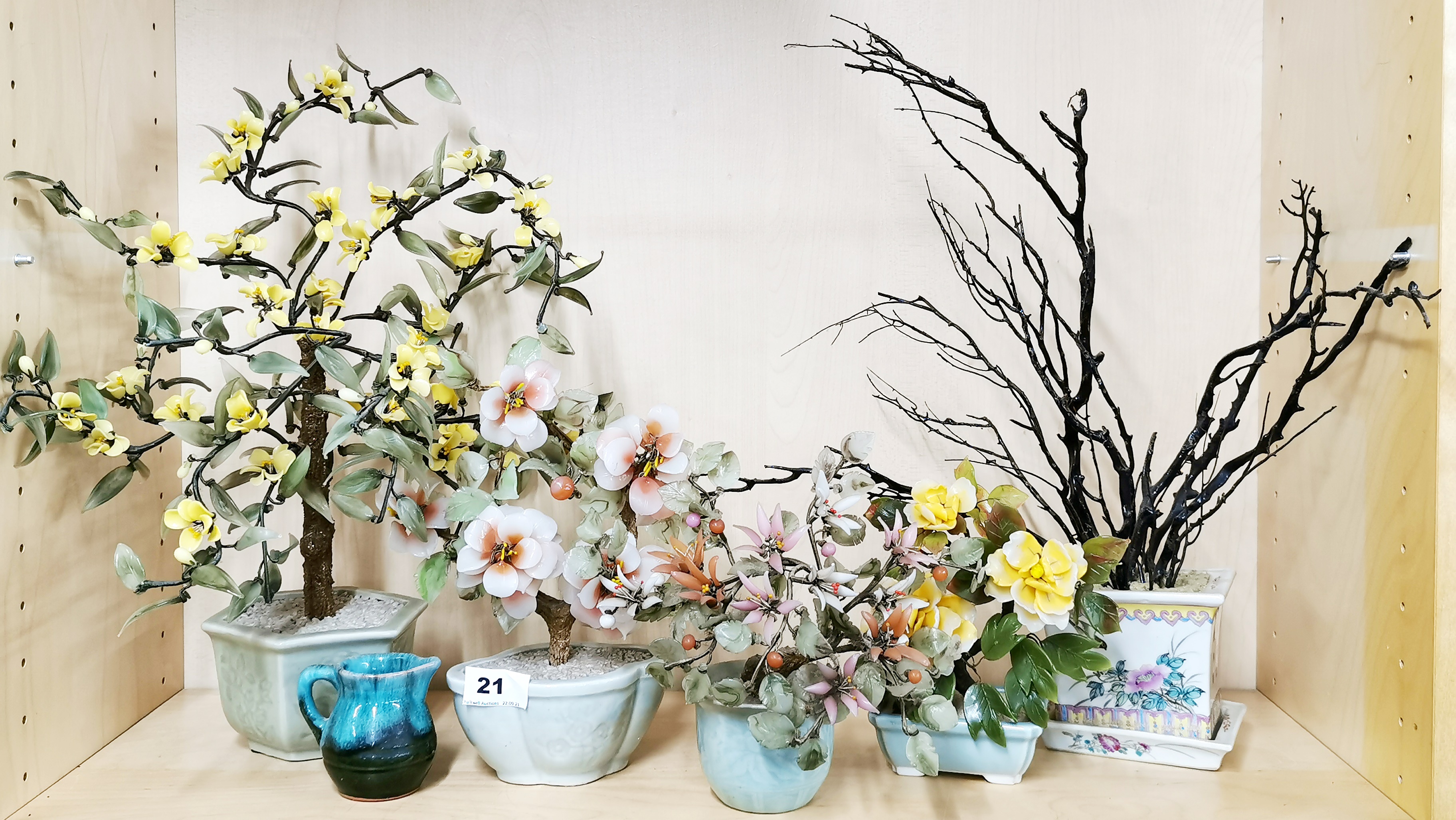 A group of four Chinese glass bonsai trees in porcelain bowls together with a further porcelain bowl