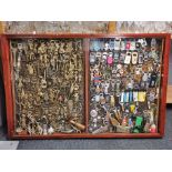 A wall cabinet containing a massive collection of bottle openers, 125 x 85cm.