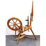 An oak spinning wheel, H. 127cm.