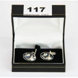 A pair of hallmarked silver and enamel tennis player cufflinks.