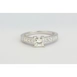 A pretty 18ct white gold ring set with a centre princess cut diamond, approx 1.04ct, with princess