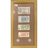 A framed group of British bank notes and coins.