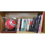 A 1990's signed Manchester United football together with a collection of team related books.