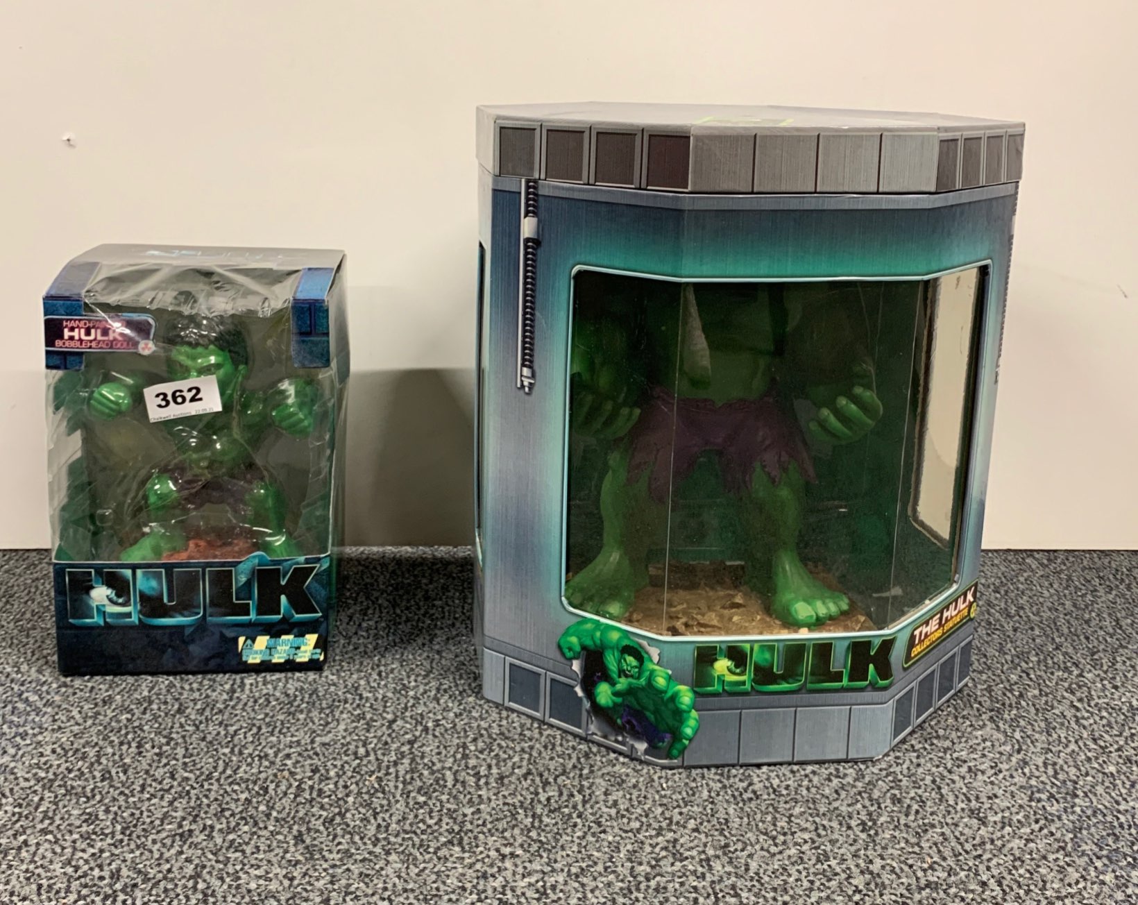 Two collectible Marvel Hulk figures.