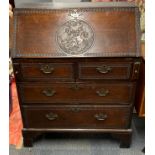 A Georgian oak bureau, carved with St. George and the Dragon, 91 x 54 x 105cm.