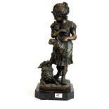 A bronze figure of a girl with a dog and two puppies on a black marble base, H. 50cm.