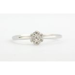 A 9ct white gold diamond set cluster ring, (R.5).