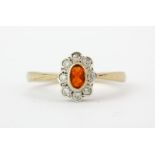 A 9ct yellow gold fire opal and diamond set cluster ring, (N).