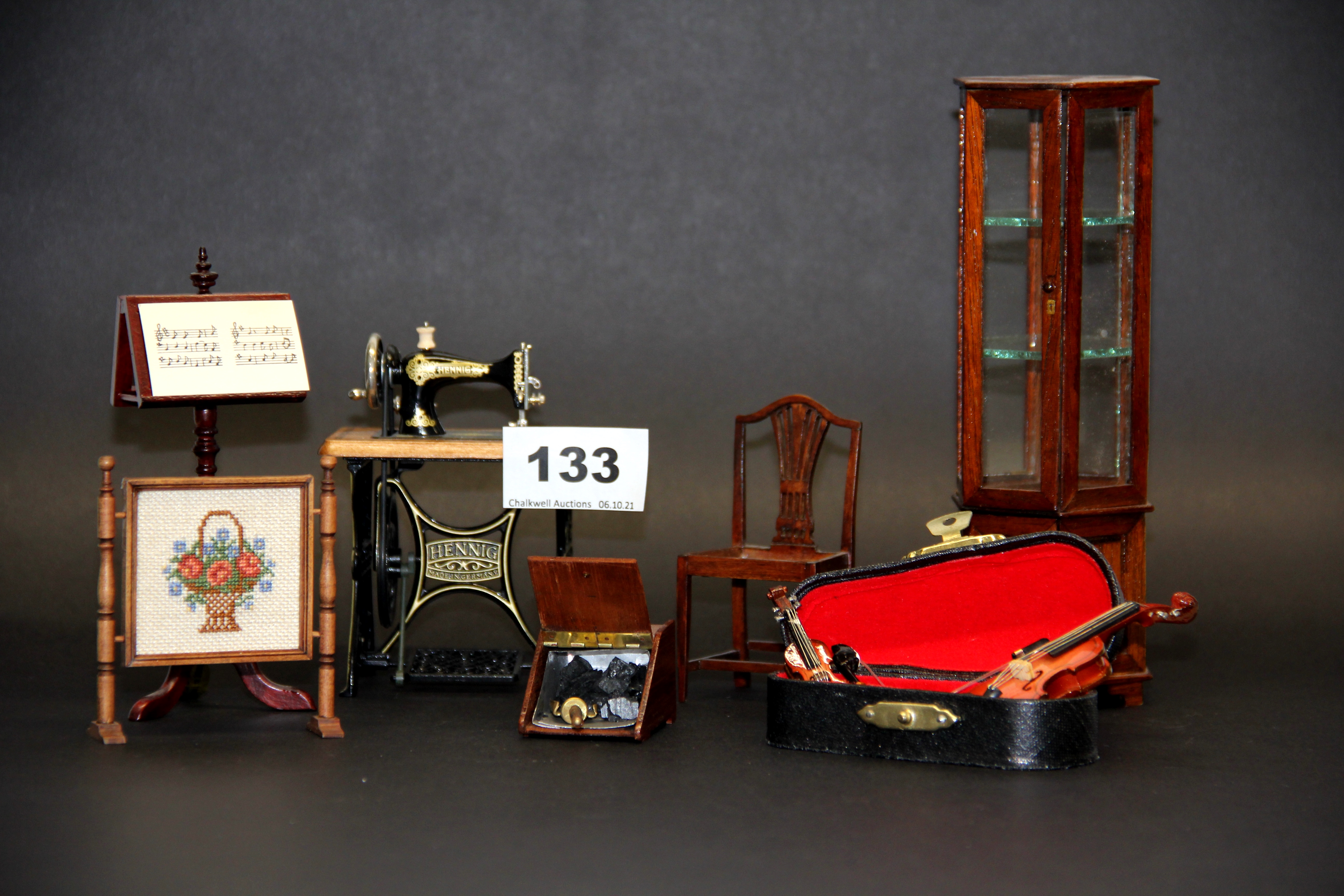 A quantity of dolls house furniture items, including sewing machine, music room items, etc.