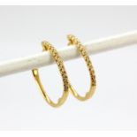 A pair of 18ct white gold diamond set hoop earrings, L. 1.7cm.