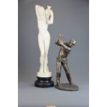 A resin figure of a nude lady together with a cold cast bronze figure of a golfer (A/F).