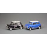 Two die cast friction driven Mini Coopers, L. 13cm.