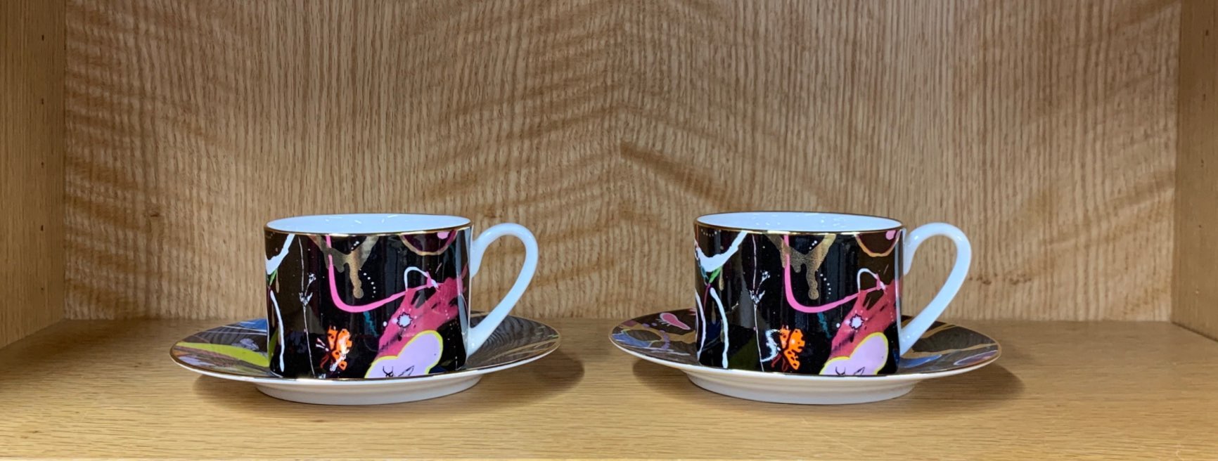 Two limited edition cups and saucers, Dan Baldwin artist series no4 88/250 and 101/250.