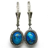 A pair of 925 silver drop earrings set with cabochon cut turquoise surrounded by white stones, L.