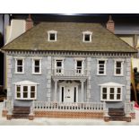 A high quality dolls house with interchangeable entrance and contents. 115 x 85 x 79cm (with large
