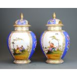 A pair of 19th / early 20th Century German porcelain jars and lids, H. 32cm. Some A/F.