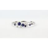 An 18ct white gold ring set with brilliant cut diamonds and sapphires, (P.5).