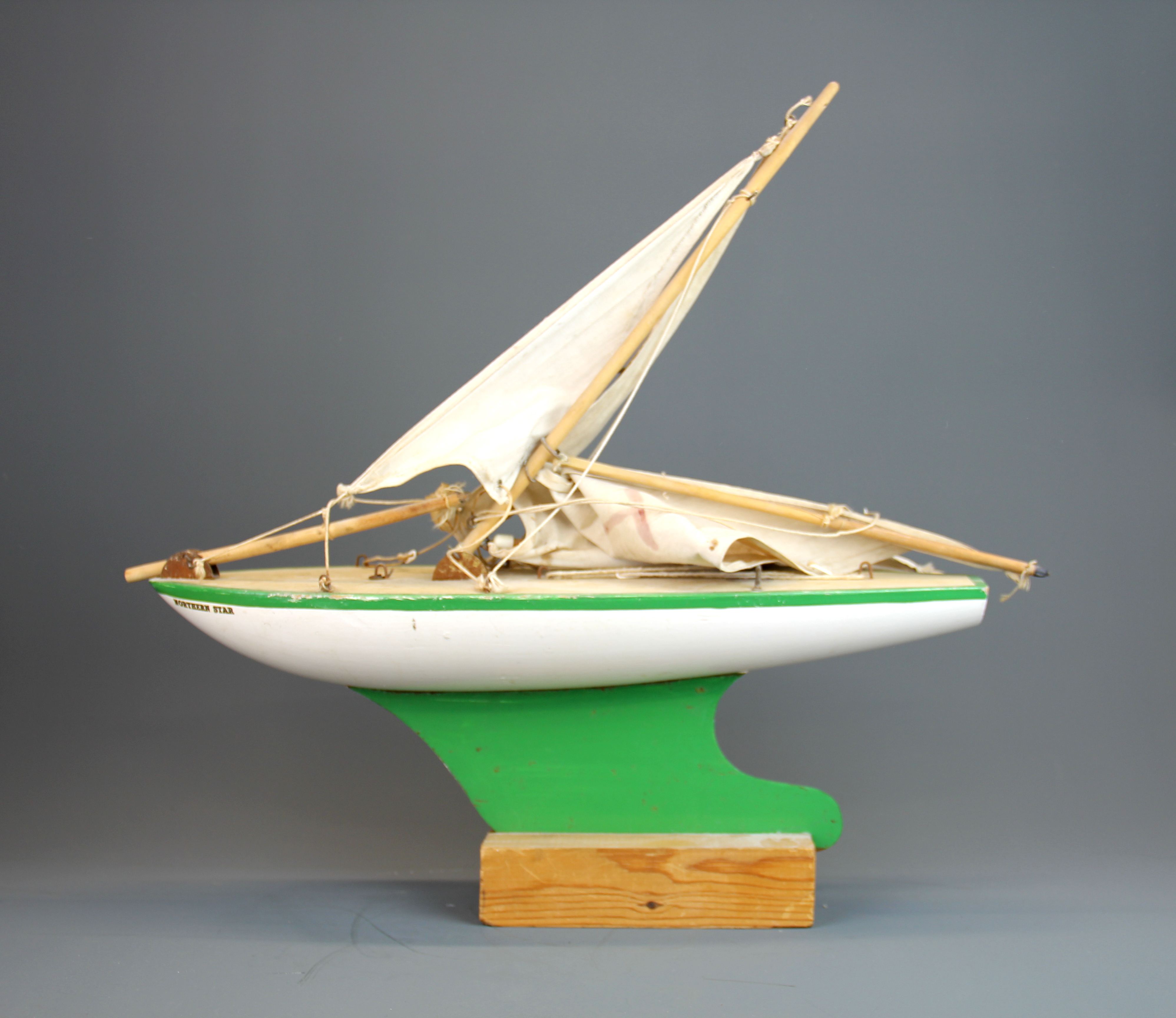 A vintage mounted model of a wooden pond yacht, L. 45cm.