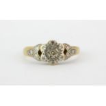 An early 18ct yellow gold and platinum diamond set cluster ring, (J).