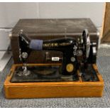 A cased Singer sewing machine.